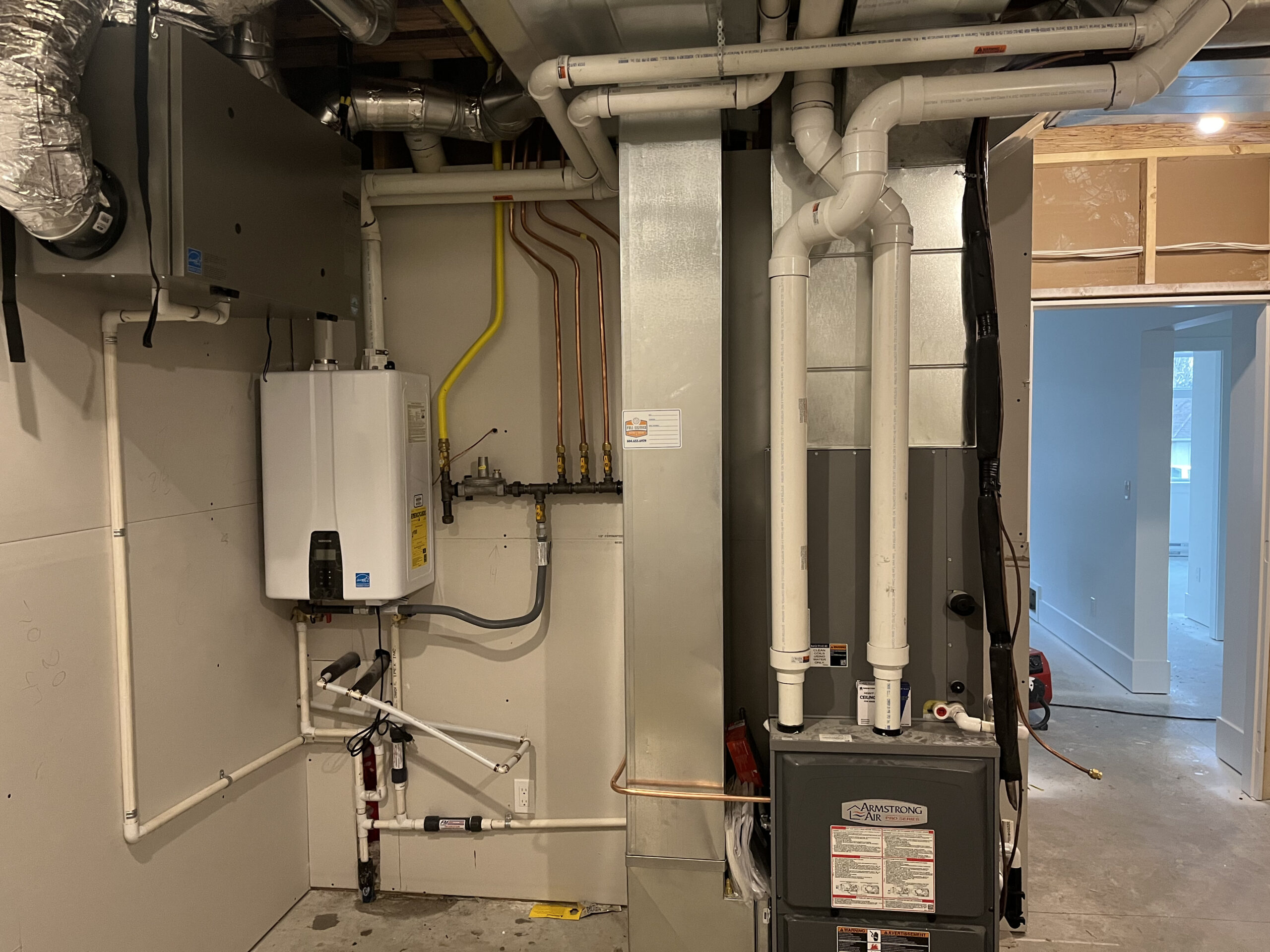 Full Service Heating and Cooling, high-efficiency furnace and tankless water heater installation in a Chilliwack mechanical room